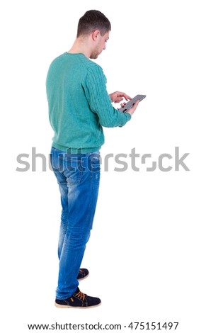 back view of business man uses mobile phone man in a green jacket and jeans standing cancer and working on plashnete.