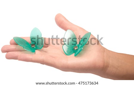 artificial butterfly on woman's hand