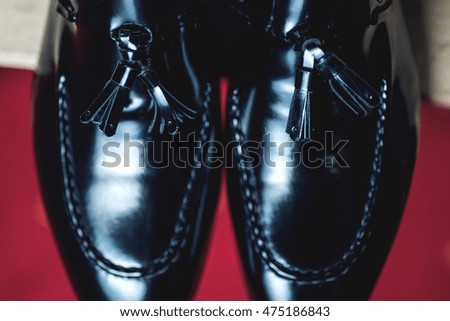 Close up picture of leather men's shoes on wooden background