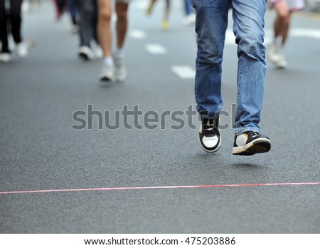 running feet of marathon racers. Royalty-Free Stock Photo #475203886