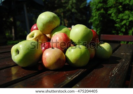 Green and red apples on the table