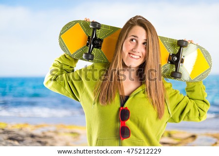Skater with green sweatshirt on unfocused background