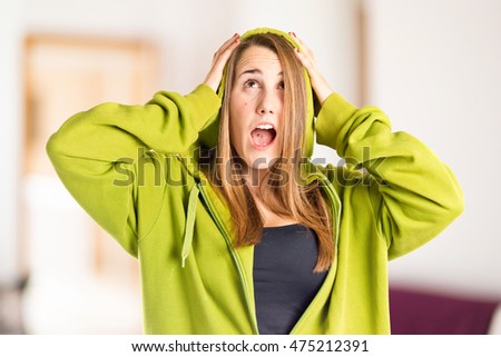 Young girl doing surprise gesture on unfocused background