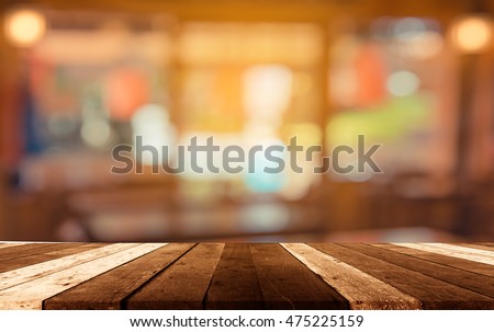 image of selective focus on surface of wood table and blur people at japanese restaurant for background usage .