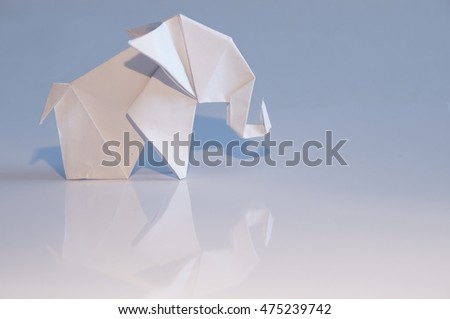 Origami elephant out of paper isolated on white background