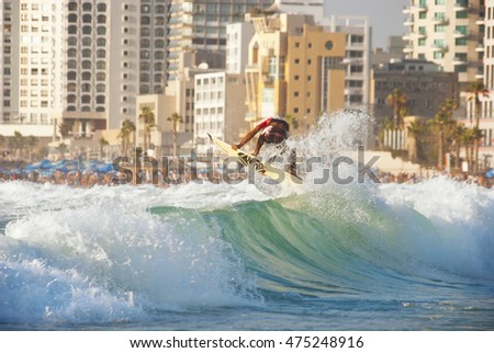 Beautiful dawn surfing, with quality waves and stunning sunset time and megalopolis urban background. Tel Aviv, Israel. Sunset surfing wave tube stock image.