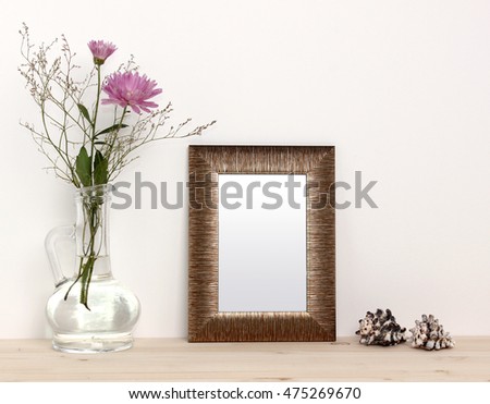 Small bronze frame mockup with flowers and sea shells