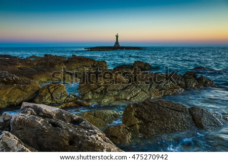 Lighthouse Razanj Croatia. Beautiful nature and landscape photo of Adriatic Sea in Dalmatia. Warm fine summer evening. Rock,stone,reef and water. Colorful sky and ocean at dusk after sunset.Nice image