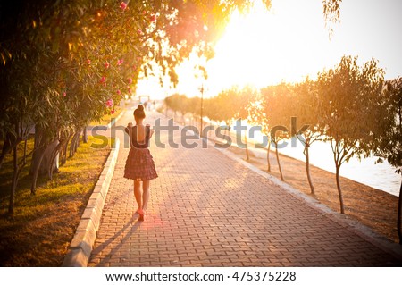 The charming girl walking along street Royalty-Free Stock Photo #475375228