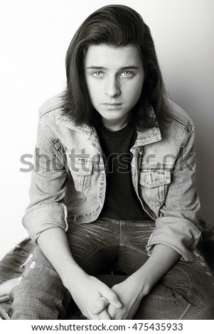 Fashion portrait of a teenager wearing jeans jacket. Monochrome