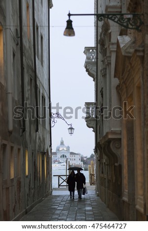Silhouette of a Couple Walking Under the Rain, Venice â?? Italy