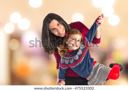 Mother and daughter together on unfocused background