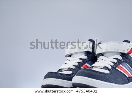 A studio photo of kids shoes                               