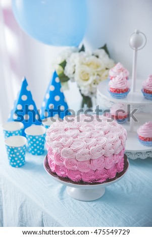 portrait of birthday party supplies. sweet corner with cake, lollies, cookies and candy