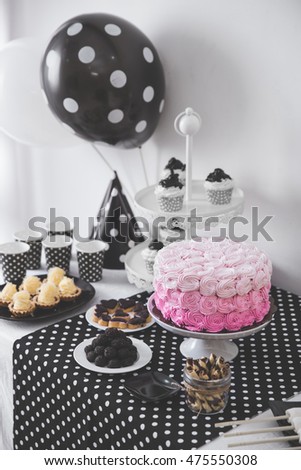 portrait of Black And White Birthday party decoration with full of cake and sweet candy
