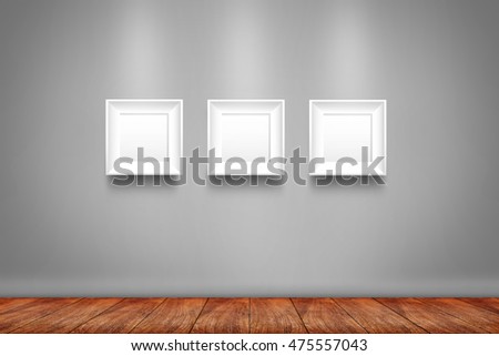 Collage of white photo frames on the wall