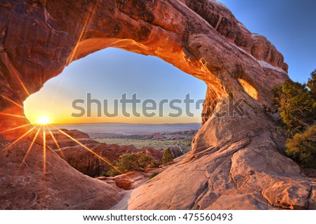 Sunrise at Partition Arch, in Arches National Park. Royalty-Free Stock Photo #475560493