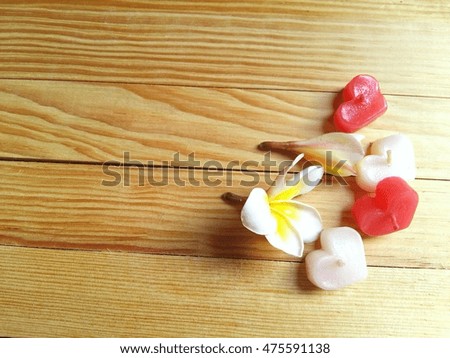 Plumeria flowers with hearts candle pattern so beautiful on wood background 