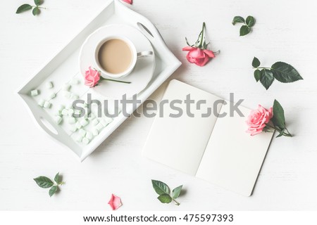 Cup of coffee, notebook and rose flowers. Vintage. Flat lay, top view. Royalty-Free Stock Photo #475597393