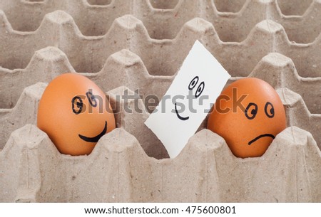 Concept photo of lies person who keep his emotion inside. Situation with two egg with funny and sad cartoon faces
