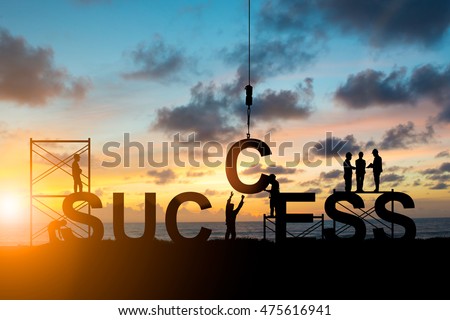 Silhouette employees work as a team to work out successfully over blurred sky at sunset Royalty-Free Stock Photo #475616941