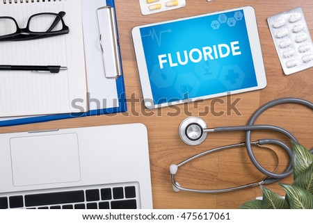 FLUORIDE Professional doctor use computer and medical equipment all around, desktop top view