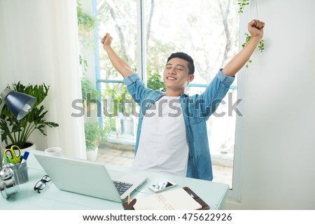 Taking a break from business. Man working at desk in office stretching his back at desk Royalty-Free Stock Photo #475622926