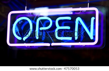 Glowing open neon sign in a window