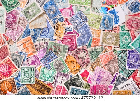 Old postage stamps from various countries as background Royalty-Free Stock Photo #475722112