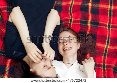 happy women  laughing and having fun on picnic top view, lying on blanket, joyful moments celebration in summer park, true emotions