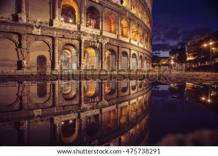 Magnificant Colosseum colisseum colliseum at night with full reflection in rain water Royalty-Free Stock Photo #475738291