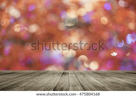 Wooden board empty table in front of colorful blurred background. Perspective brown wood over bokeh light, can be used for display or present your products.Mock up your products