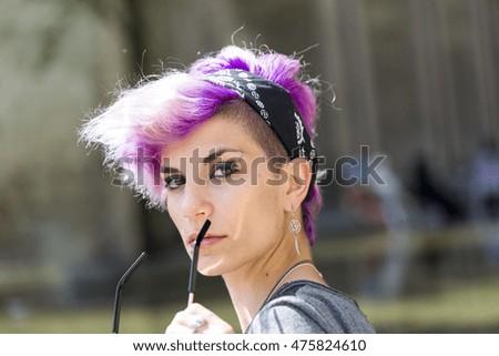 young girl alternative model with pink hair tattoo in street photo set with glasses
