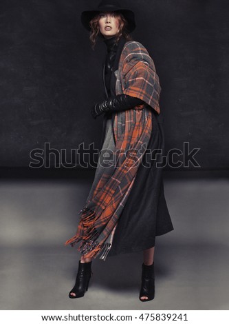 Fashion shot of a beautiful professional model, posing in stylish autumn clothes.