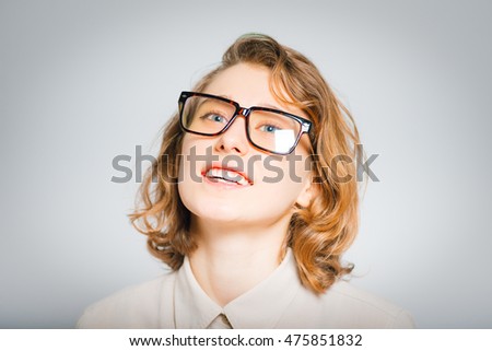 a beautiful young woman very happy, a dream come true, close-up, isolated on a gray background