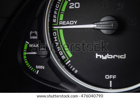 Close up photo of a tachometer of a modern hybrid car. Battery indicator.