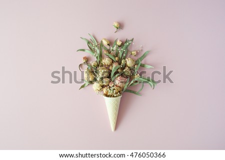 waffle cone with roses bouquet on pink background, flat lay, top view
