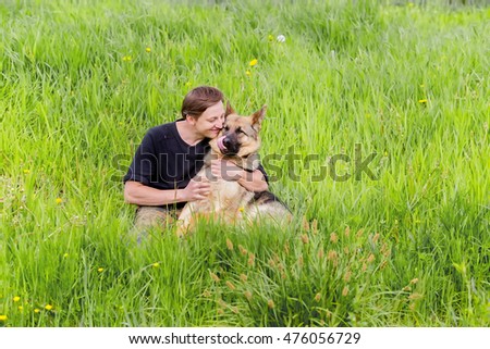 host kisses his dog. a German shepherd dog. Training