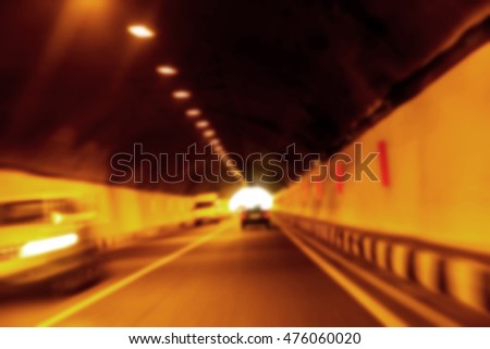 Abstract Motion Blur Background road tunnel with moving cars and light at the end. For use as a creative design blank. Light line of traffic in the tunnel lighting car highway