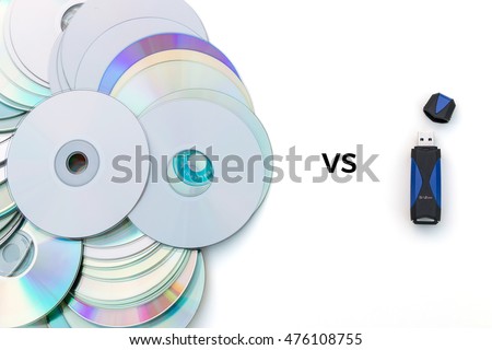 USB flash drive versus stack of CDs on white background
