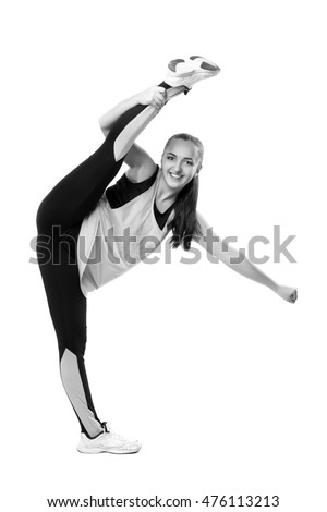 Young professional cheerleader  stands in vertical splits. Isolated over white. Black and white photography