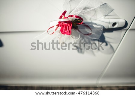 beautiful red rose lying on a white car