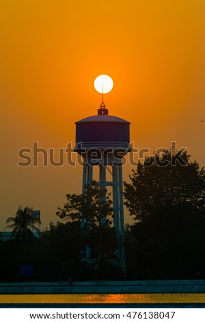 Beautiful sunset, water tower tank , Water Tank Tower with cloud storm
