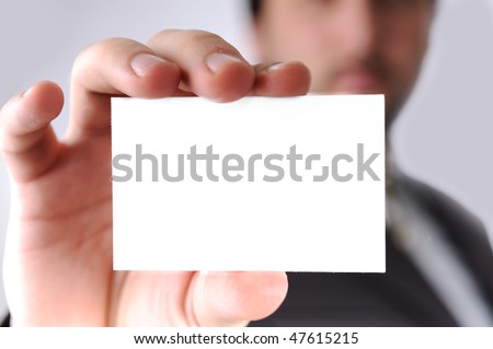  Business man handing a blank business card over white background