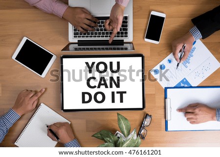 YOU CAN DO IT Business team hands at work with financial reports and a laptop, top view