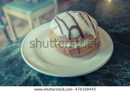 Sweet Ice bun on white plate, Vintage style