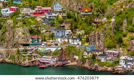 Aerial view of beautiful colorful houses built on the rocky slope of the Signal Hill in St. John's Newfoundland, Canada Royalty-Free Stock Photo #476203879