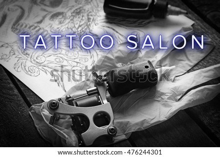 Workplace of tattoo master with text Tattoo Salon