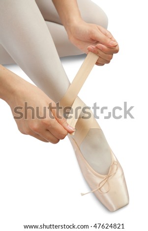 Closeup of  Ballerina putting on pointes over white