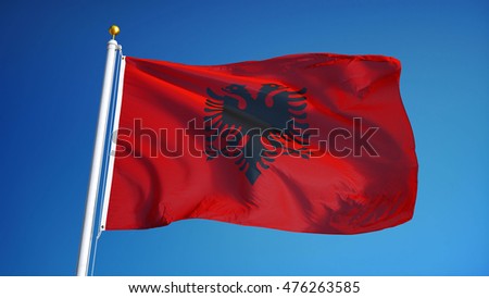 Albania flag waving against clean blue sky, close up, isolated with clipping mask alpha channel transparency, perfect for film, news, digital composition